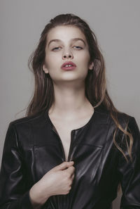 Fashion portrait of a young woman wearing leather jacket