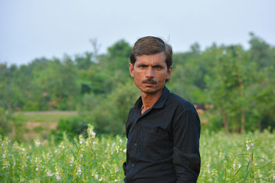 Portrait of man standing on field