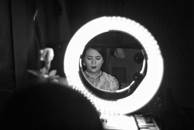 Portrait of woman with reflection on mirror