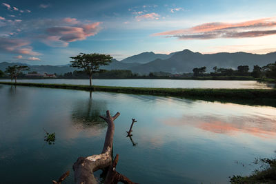 Scenic view of lake against sky during sunset