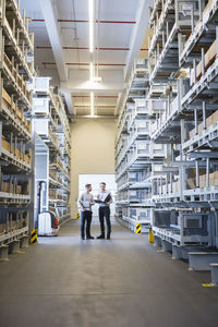 Two men talking in factory warehouse