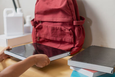 Midsection of man using laptop on table