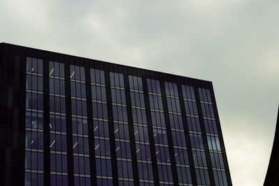 Low angle view of office building against sky