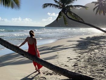 Full length of woman on beach against sky