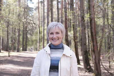 Portrait of a smiling young woman in forest