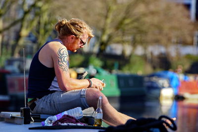 Midsection of man sitting outdoors