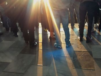 Low section of people walking on street