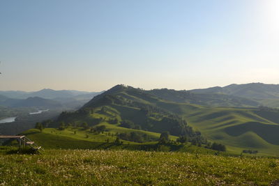 Scenic view of field and mountains against sky