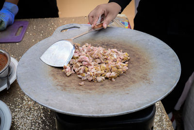 Cropped hand of person preparing food