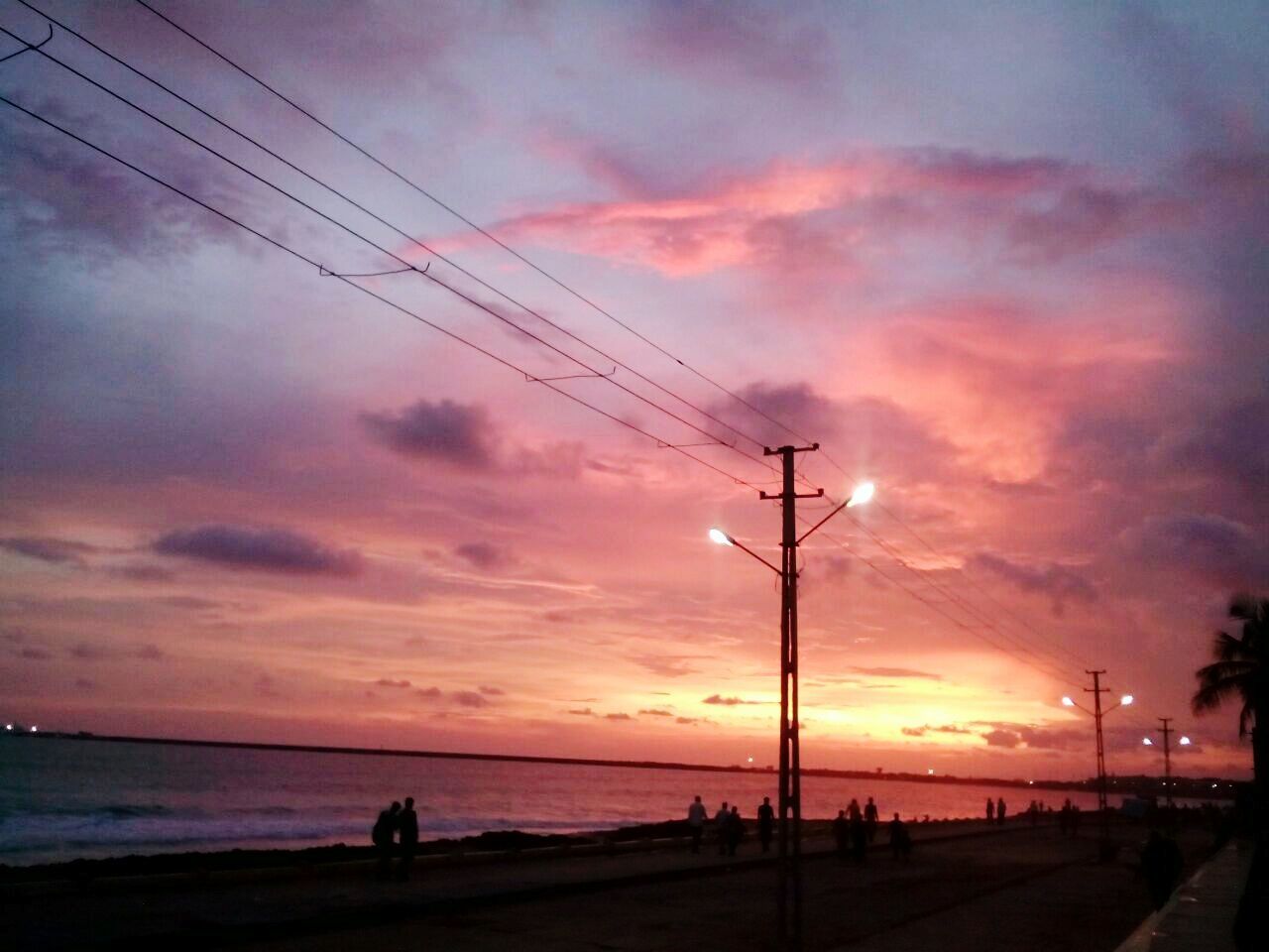 sunset, silhouette, sky, cloud - sky, cable, nature, power line, connection, electricity, sea, outdoors, scenics, beauty in nature, water, beach, electricity pylon, technology, horizon over water, no people