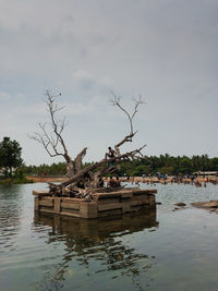 Boat moored in lake against sky