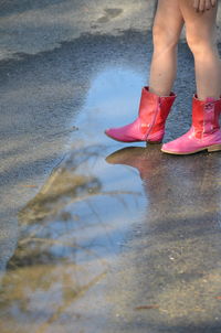 Low section of woman standing in water