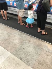 Low section of people standing on road