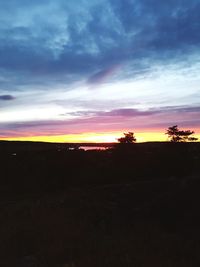 Scenic view of silhouette landscape against sky at sunset