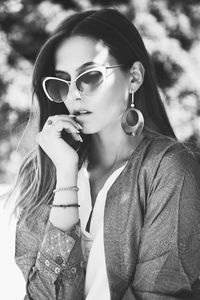 Fashionable young woman wearing sunglasses outdoors