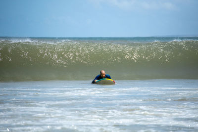 Man on sea against sky