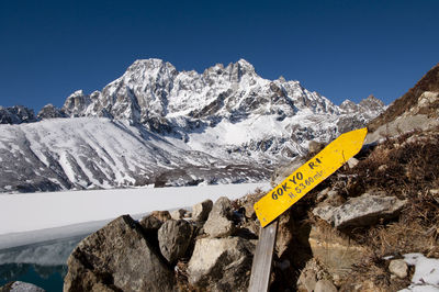 Scenic view of snowcapped mountains against clear blue sky