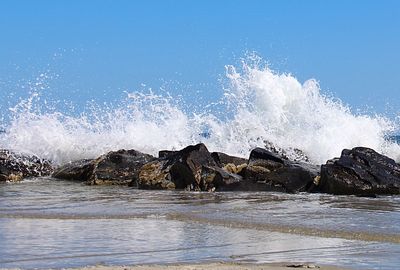 Scenic view of sea against clear blue sky