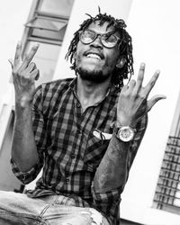 Midsection of man with arms raised