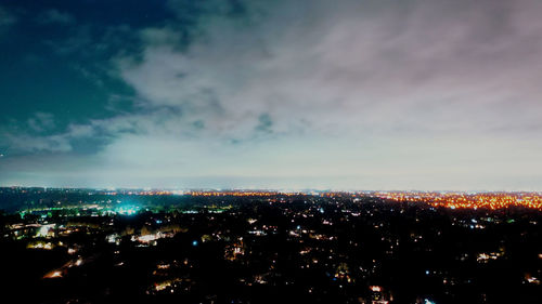 High angle view of illuminated city buildings against sky