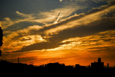 Silhouette of built structure at sunset