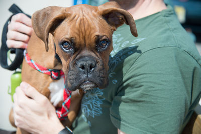 Close-up of man holding dog