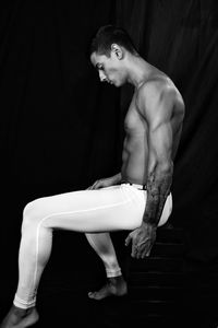 Side view of woman sitting on chair