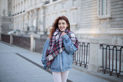 Portrait of a smiling young woman in city