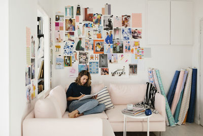 Woman sitting on sofa in living room