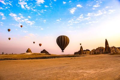 Hot air balloons flying over land