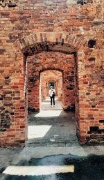 Woman standing amidst old ruin