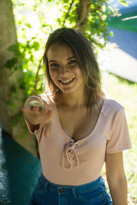 Portrait of smiling young woman standing outdoors