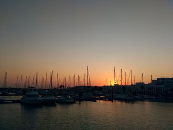 Sailboats in marina at sunset