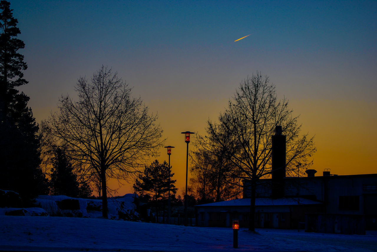 STREET AND BUILDINGS AGAINST SKY DURING WINTER