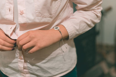 Midsection of woman wearing shirt