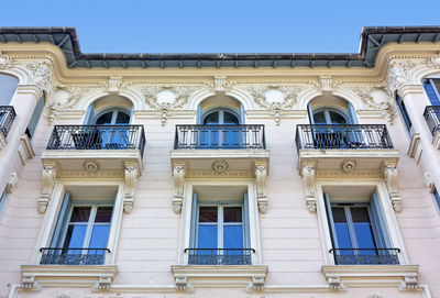 Low angle view of building against clear blue sky