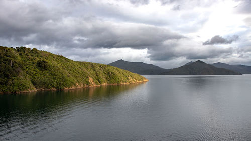 Scenic view of lake and mountains against sky