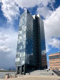 Low angle view of modern buildings against sky in city