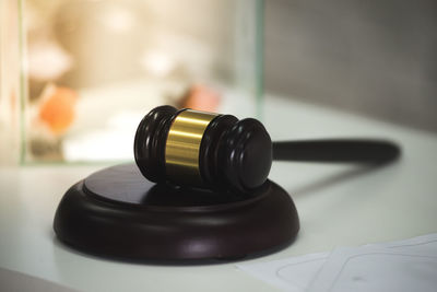 Close-up of gavel on table