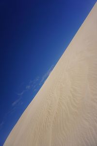 Scenic view of desert against blue sky