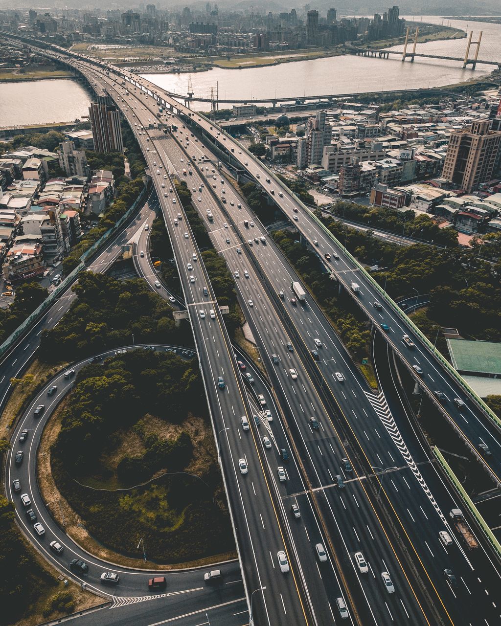 transportation, connection, traffic, bridge - man made structure, city, architecture, road, highway, car, elevated road, aerial view, overpass, mode of transport, high angle view, land vehicle, road intersection, motion, built structure, cityscape, no people, modern, outdoors, day
