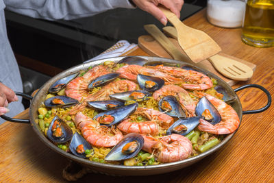 traditional spanish paella with shrimp and mussels ina rustic kitchen setup typical spanish cuisine