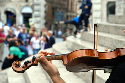 People playing guitar on street in city