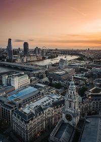 High angle view of buildings in city during sunset