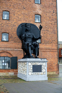 Statue against building