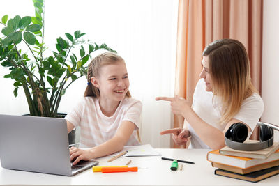 Mother helping daughter with homework