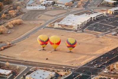 High angle view of hot air balloon flying over city