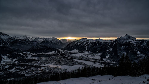 Scenic view of snowcapped mountains against sky during sunset