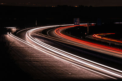 Light trails on road in city at night