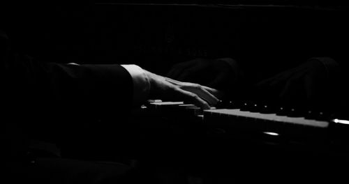 Close-up of man playing piano